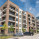 New Luxury Multistorey Apartment Community With Parked Cars Near Dallas, Texas