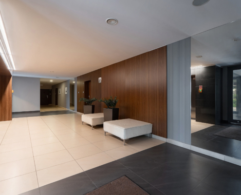 Modern Residential Lobby Wood Panels, Large Mirror, Tiled Floor